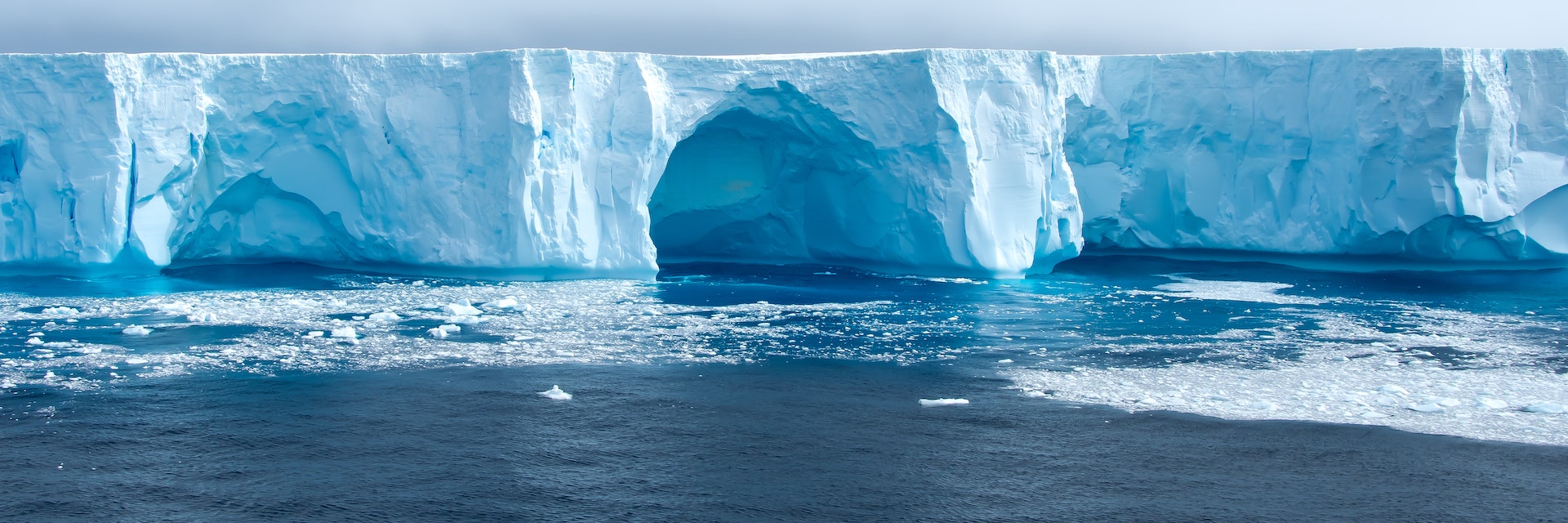 Beautiful blue iceberg and ice floe in Admiralty bay, King George Island Antarctica.