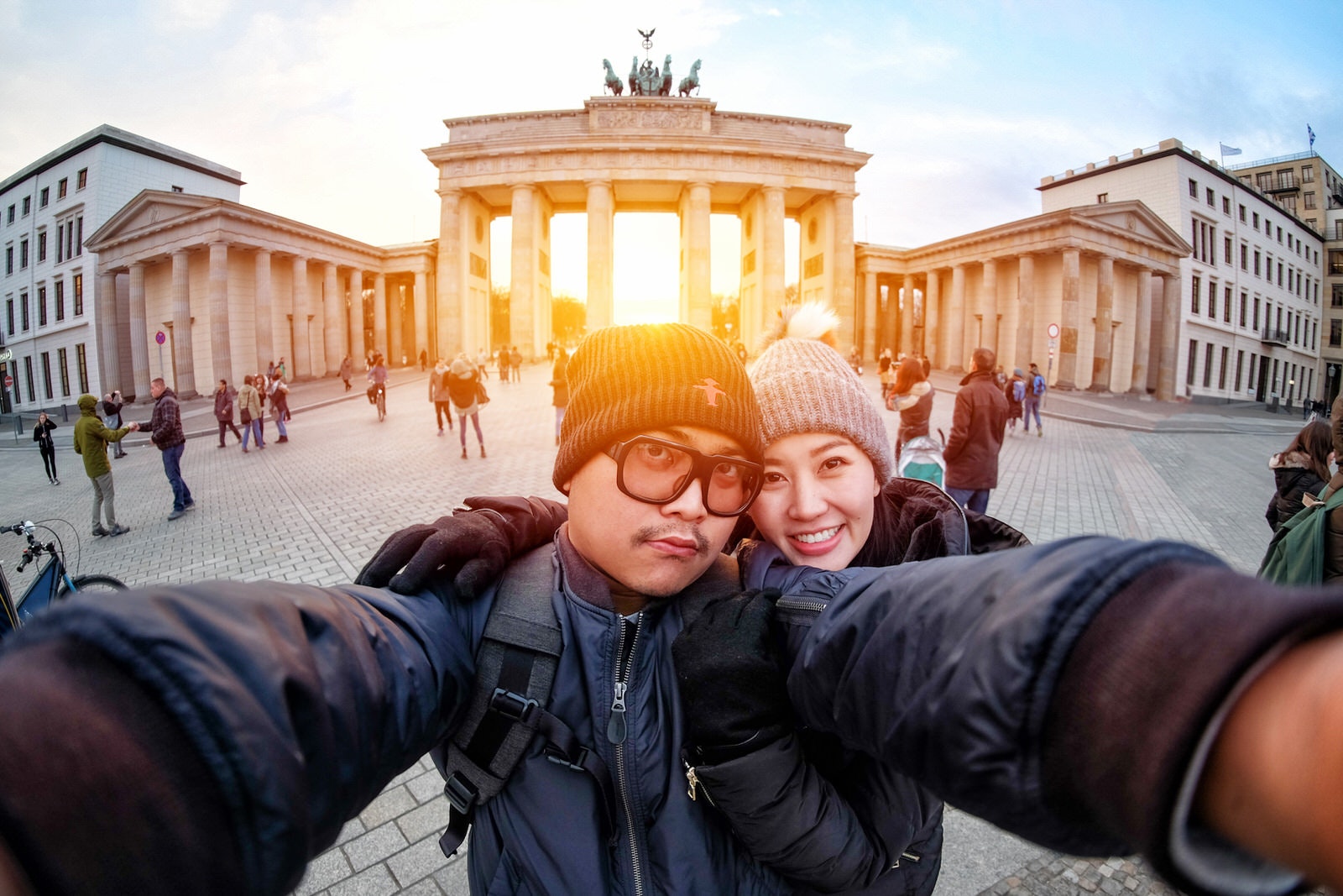 Couple take a selfie at Brandenburg Gate at sunset, Berlin
