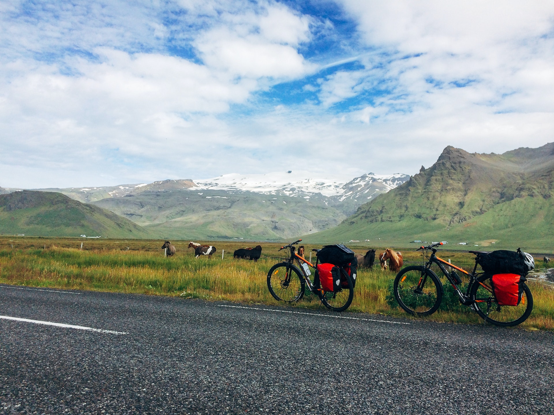 Two touring mountain bikes at the roadside with dramatic Icelandic landscape background.