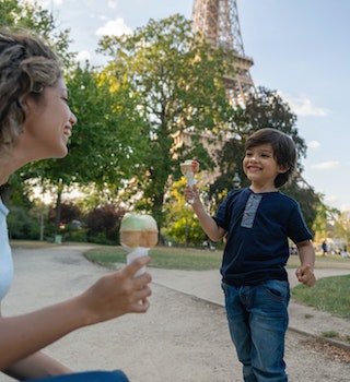 Happy mother and son eating an ice cream outdoors near the Eiffel Tower in Paris - lifestyle concepts
1182973478