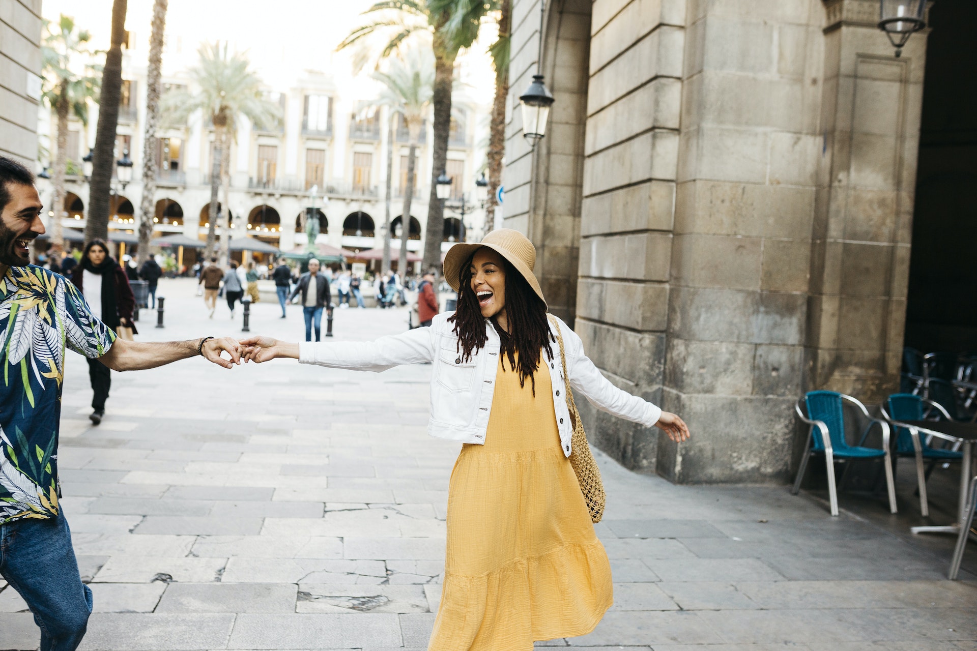 Young multiracial couple dancing on the city center of Barcelona, Catalonia