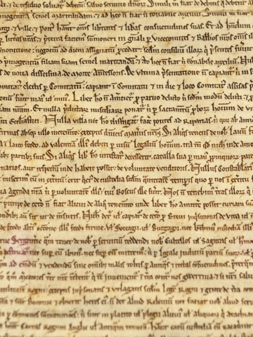 Magna Carta in Salisbury Cathedral, England. It is a charter agreed by King John of England at Runnymede, near Windsor, on 15 June 1215. First drafted by the Archbishop of Canterbury to make peace between the unpopular King and a group of rebel barons, it promised the protection of church rights, protection for the barons from illegal imprisonment, access to swift justice, and limitations on feudal payments to the Crown, to be implemented through a council of 25 barons. It influenced the early American colonists in the Thirteen Colonies and the formation of the American Constitution in 1789, which became the supreme law of the land in the new republic of the United States.