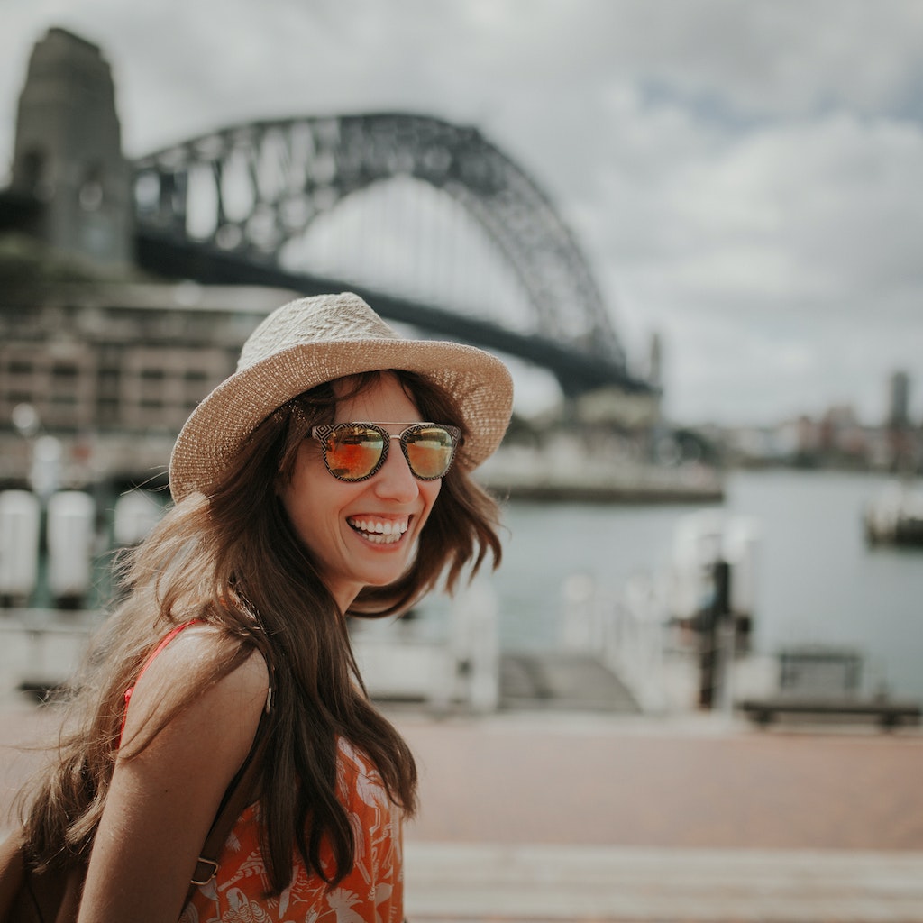 Smiling girl in hat and sunglasses posing in Sydney Harbour
667360864
Happy smiling woman exploring Sydney, with Harbour Bridge in the background