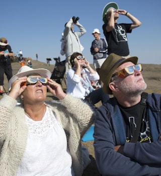 MENAN, ID - AUGUST 21: Angela and Chris Willis-Richards of London get their photo taken as they wear eclipse glasses on Menan Butte to watch the eclipse on August 21, 2017 in Menan, Idaho. Millions of people have flocked to areas of the U.S. that are in the "path of totality" in order to experience a total solar eclipse. (Photo by Natalie Behring/Getty Images)
836360358
Solar Eclipse