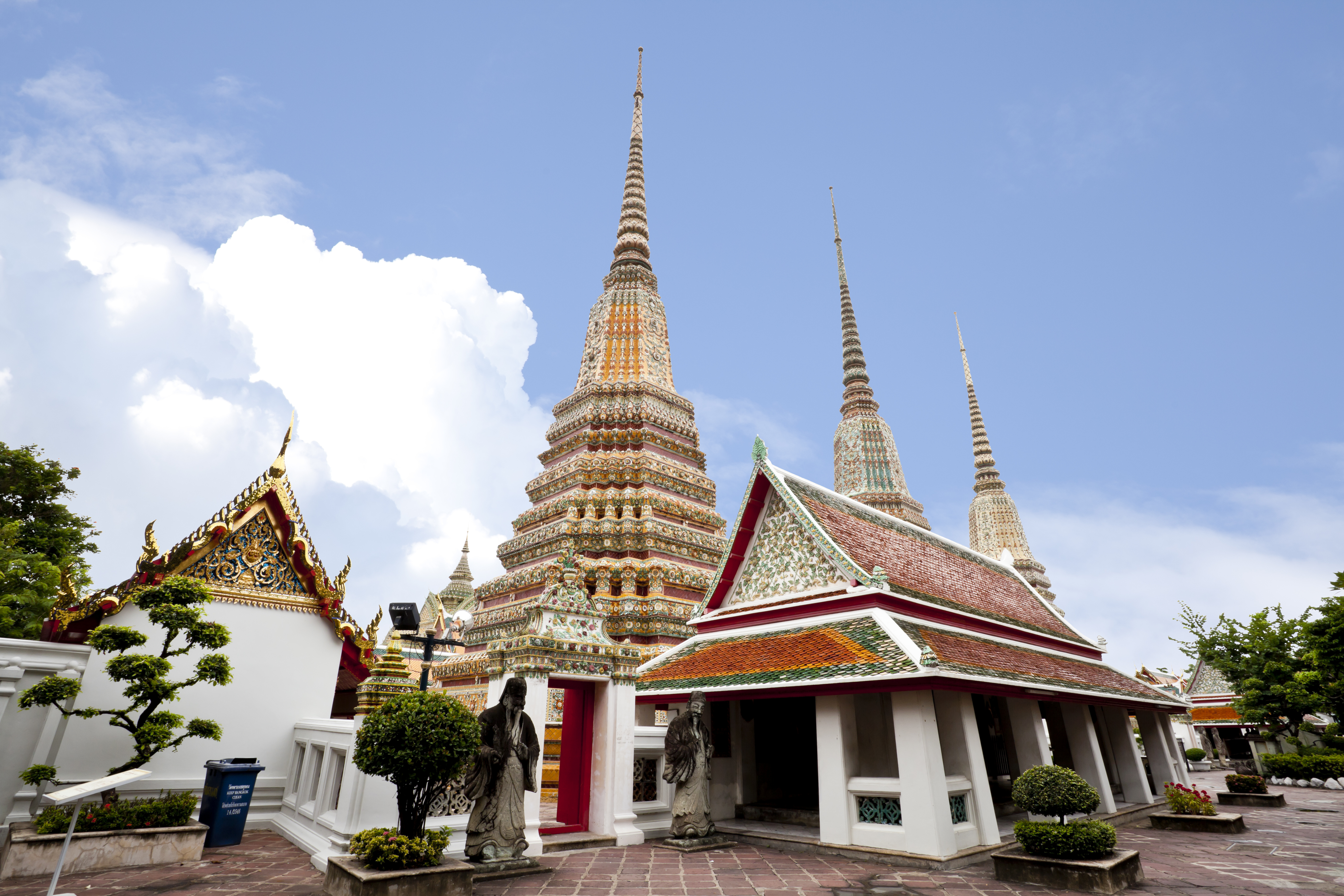 The golden stupas of Wat Pho sit quiet and in peace against the piercing blue skies of Bangkok, Thailand