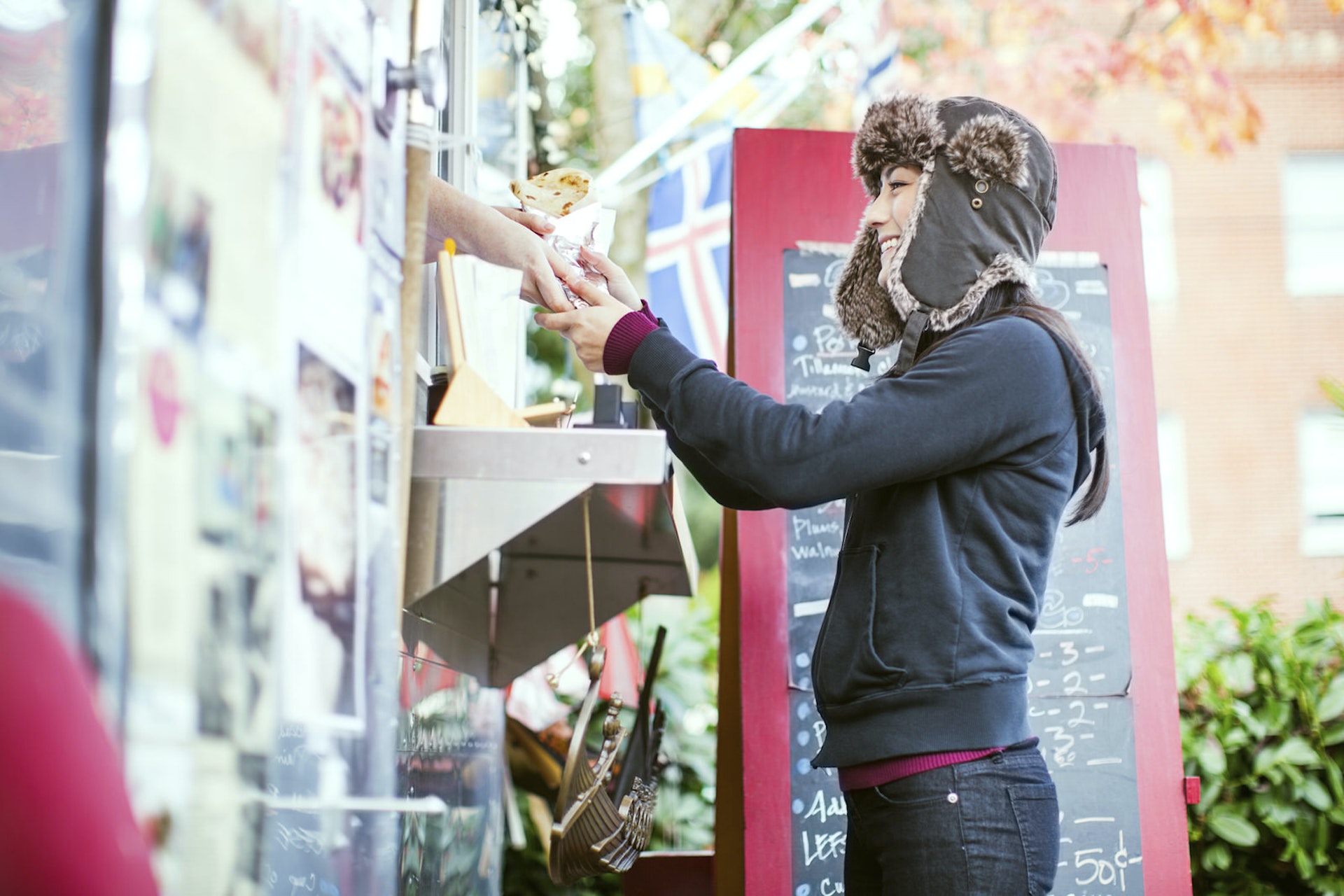 A young woman orders food from a food truck in Portland, Oregon.