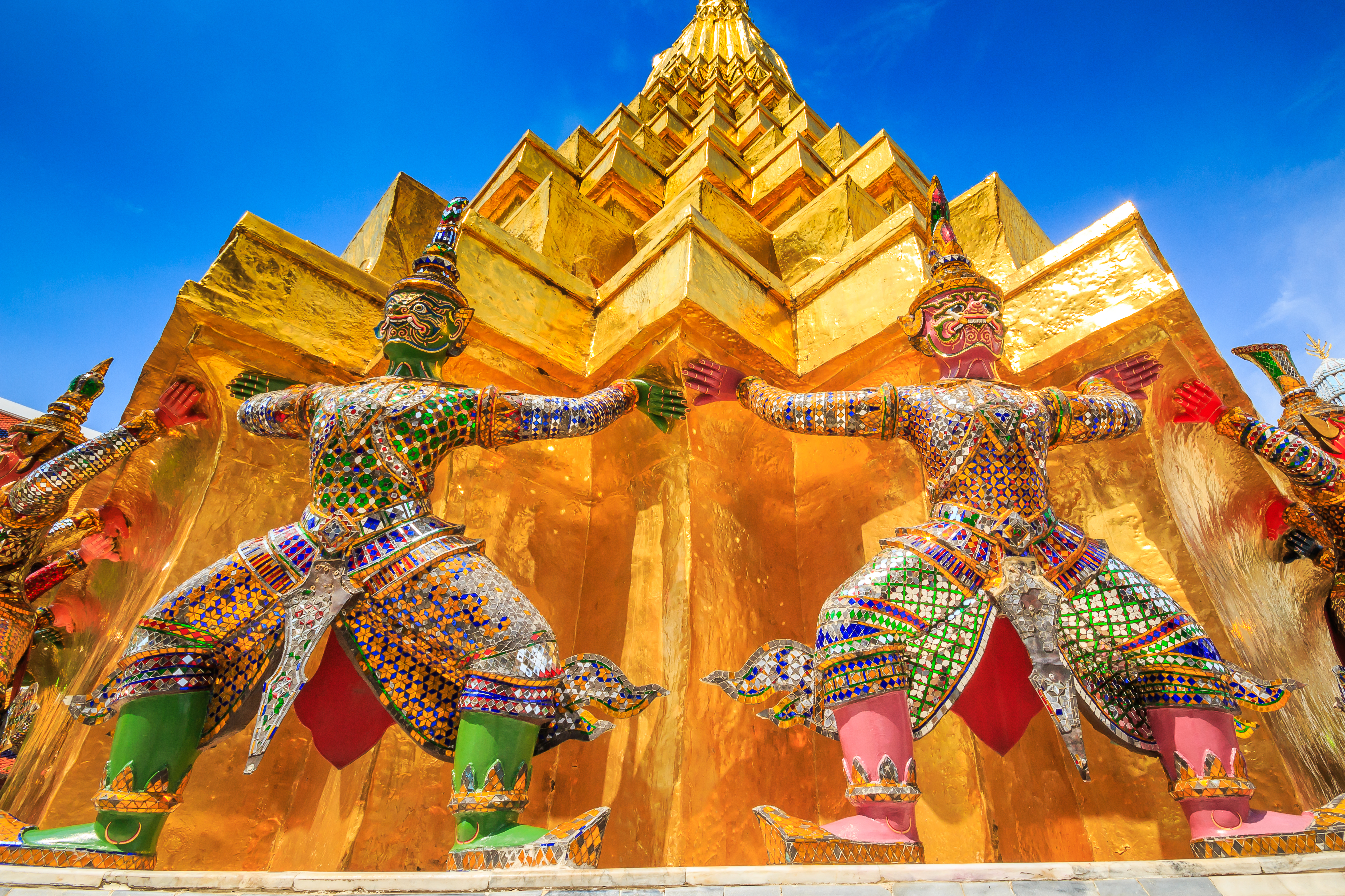 Statues of the yaksha, two brawny guardian giants from the Ramakian epic, greet visitors at Wat Phra Kaew.