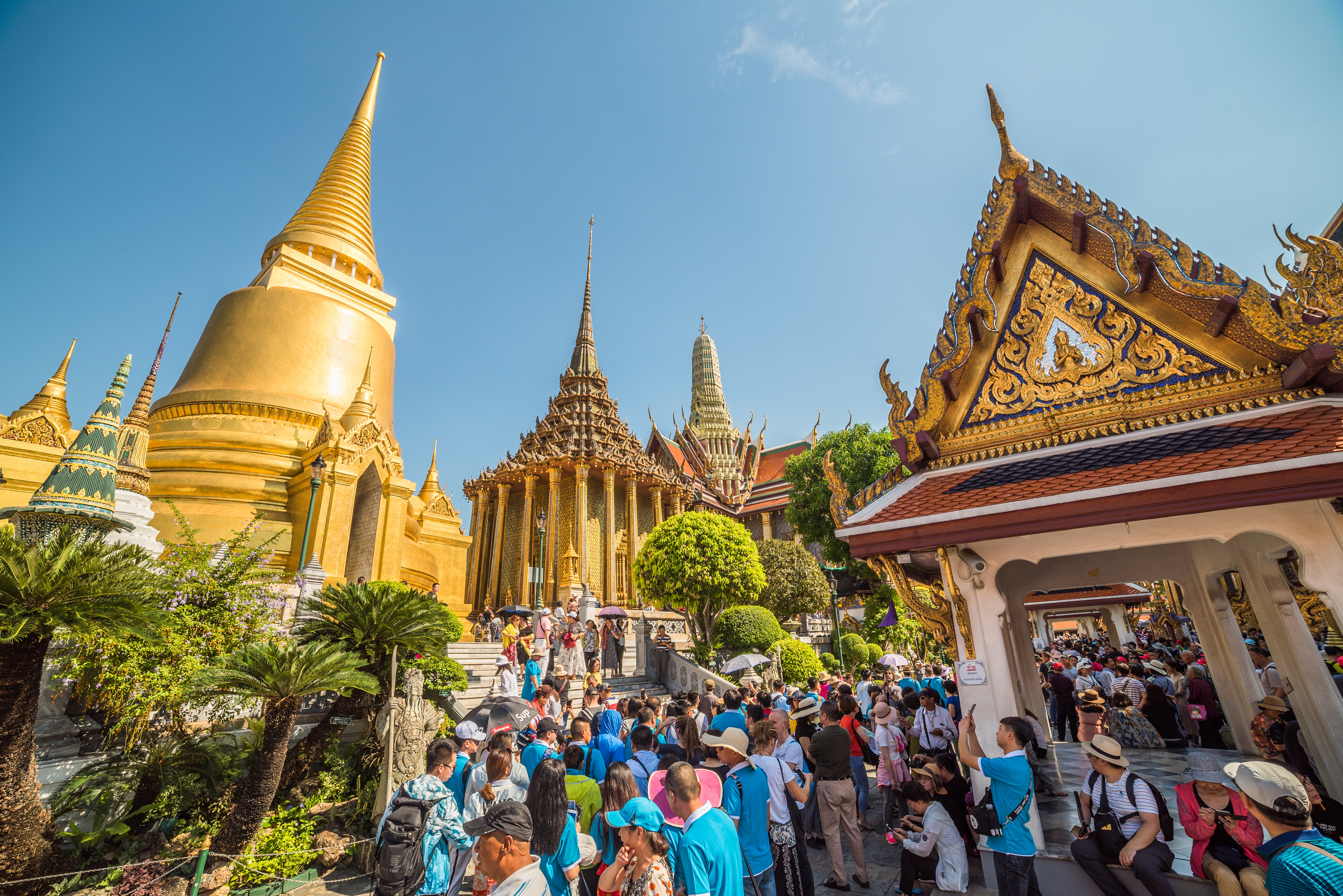 Many Tourists gather around Wat Phra Kaew, the Temple of Emerald Buddha at Bangkok's Grand Palace