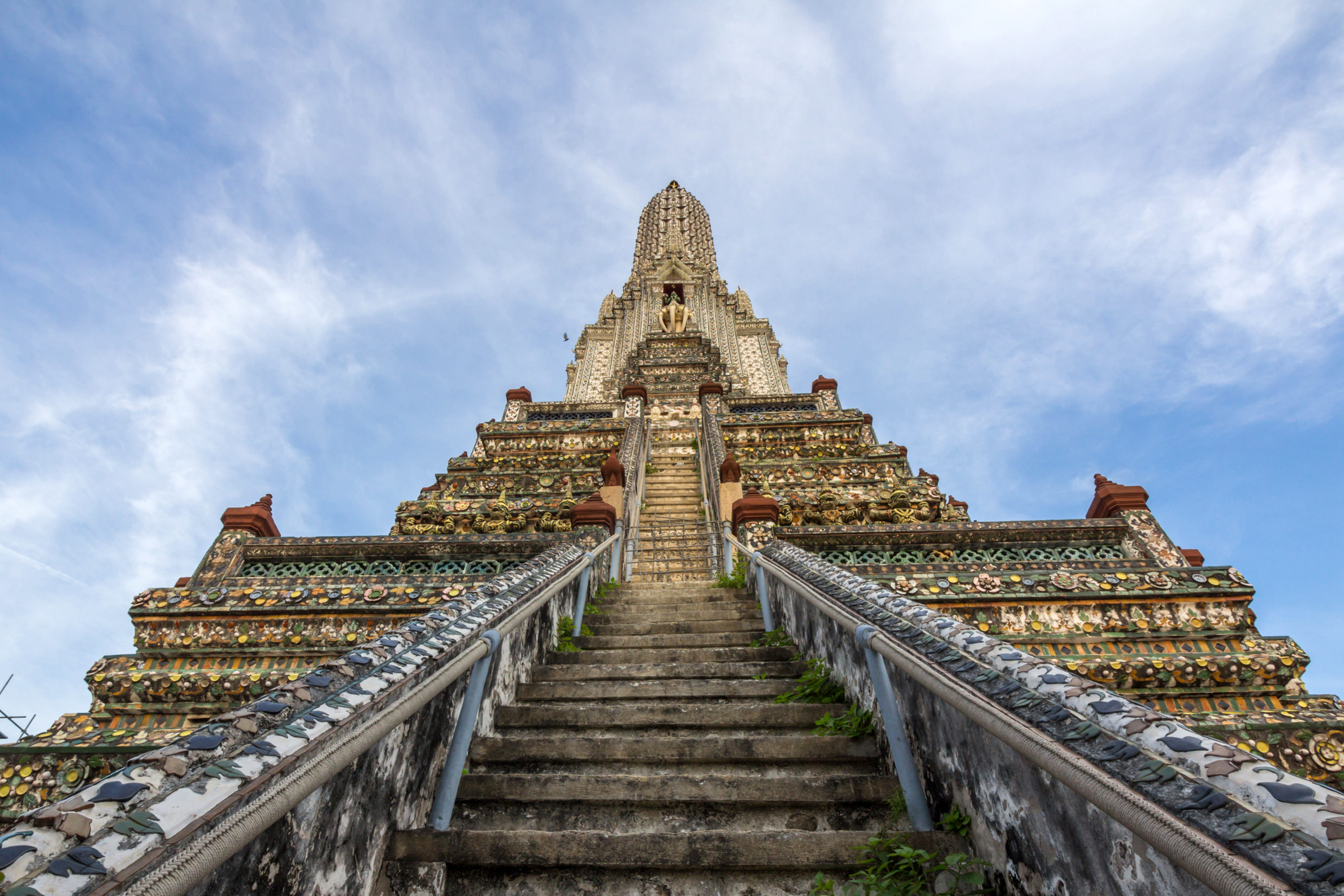 Looking from the bottom of the steps which lead up to the 82m-high þrahng at Wat Arun, Bangkok.