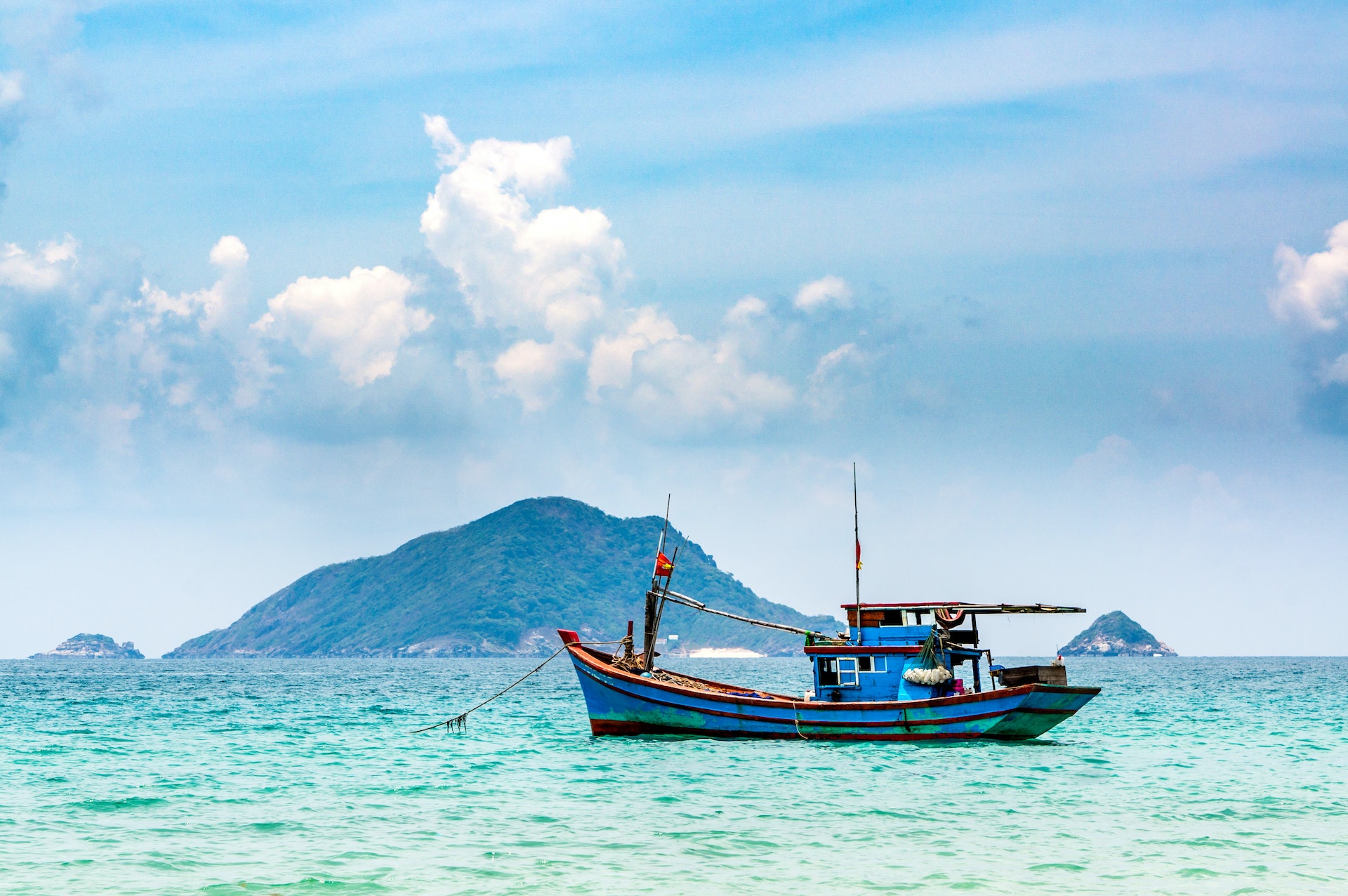 A fishing boat floating in blue waters off the Con Dao islands