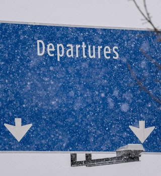 A "Departures" sign during a snow storm at Seattle-Tacoma International Airport (SEA) in Seattle, Washington, US, on Tuesday, Dec. 20, 2022. An estimated 112.7 million people will travel 50 miles or more from Dec. 23 to Jan. 2, up by 3.6 million from last